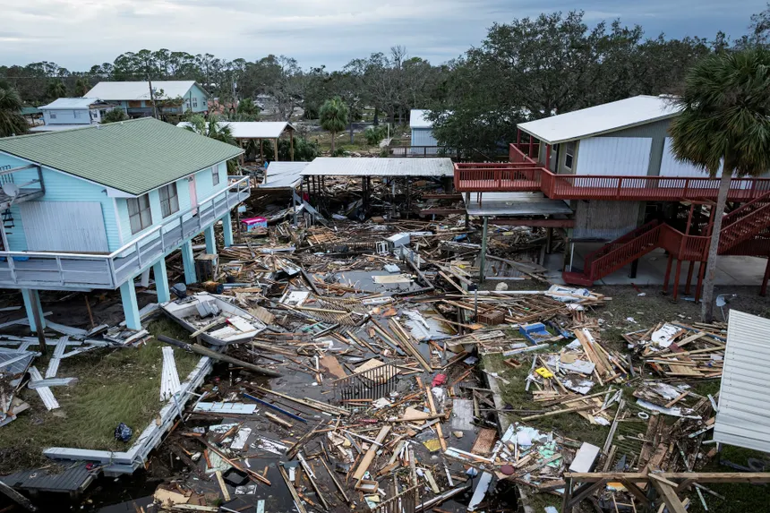 Hurricane damage and debris surrounding elevated homes